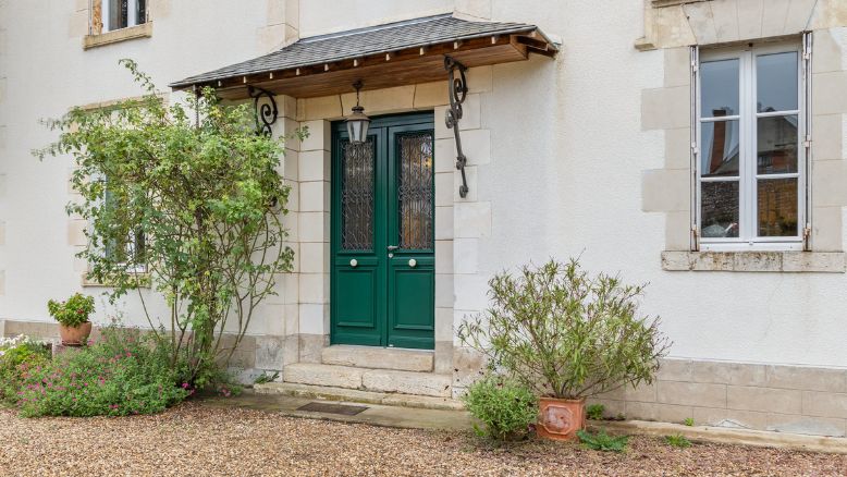 porte d'entrée en bois sur mesure avec une grille et des décors moulurés